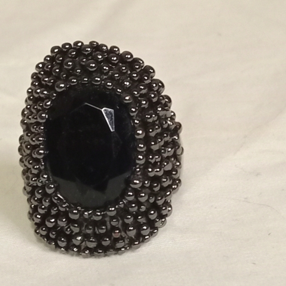 Unique Avon Ring. Black Stone with metal bumps around it.